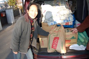 Mrs. Tayama with one of the three 30 kilograms of rice donated by friends in Niigata