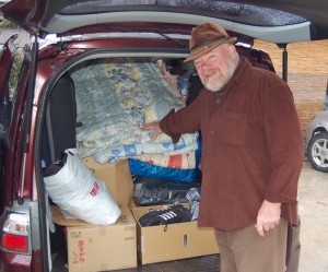 Charles Begley before van stocked with food and goods for friends in Sendai