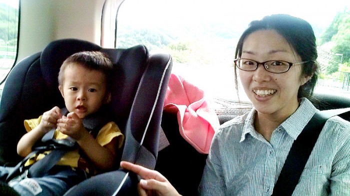 Lady with her son in the back seat of the car that took me to Nagano City on my way back home
