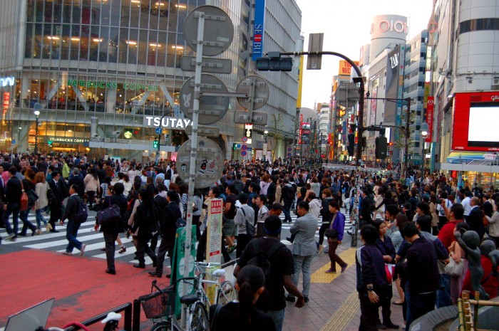 People crossing the street in front of Shibuya Station in Tokyo.