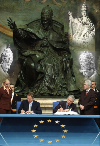 [Former] PM of England Tony Blair signing the New European Union Constitution. The statue behind him is Pope Leo X. Rome is the power behind the European Union!