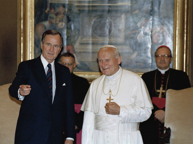 President George H.W. Bush with Pope John Paul II in the papal library at the Vatican on May 27, 1989, 
