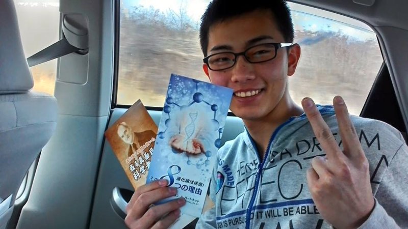 Young man in car #6 holding a tract by John G. Hartnett that exposes evolution as a pseudo -science.