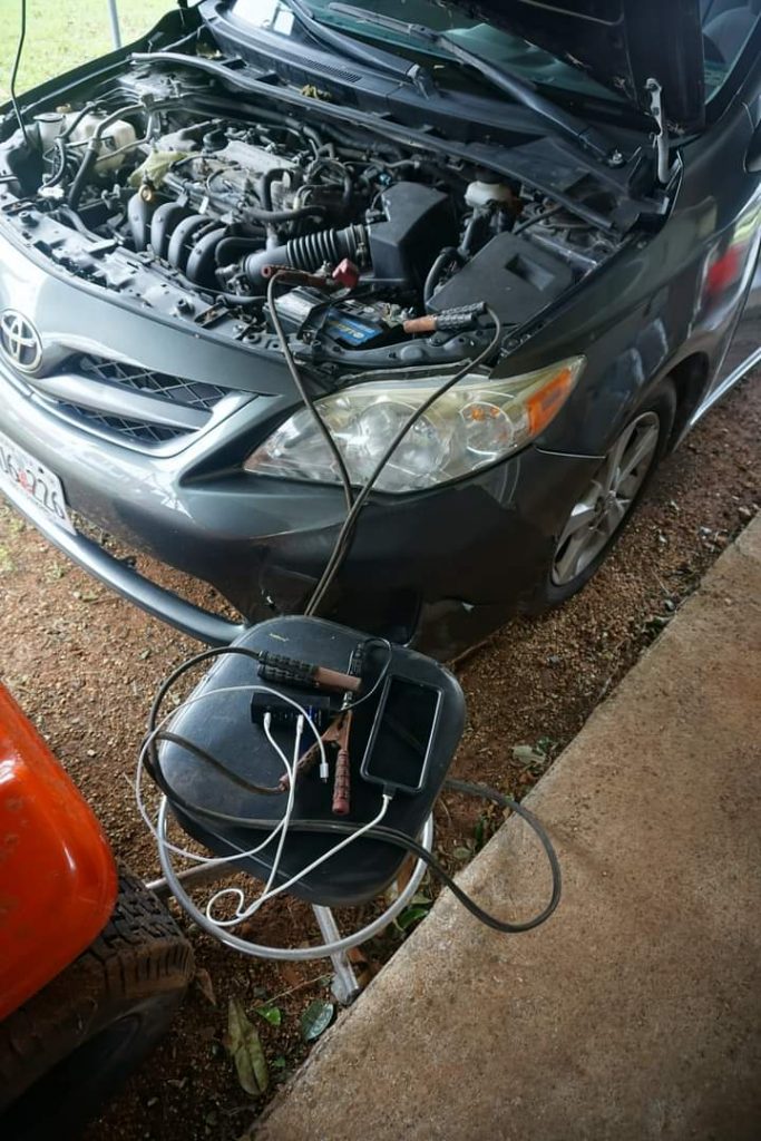 Charging our phones from a car battery.
